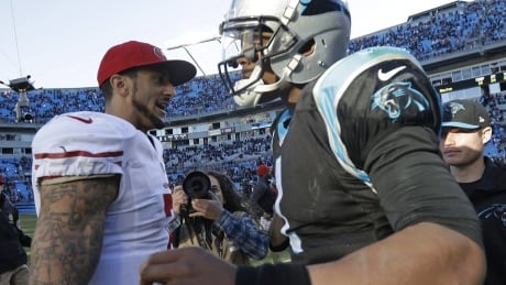 Colin Kaepernick, left, and Cam Newton embrace after a San Francisco-Carolina playoff game in 2014. 49ers Panthers Football