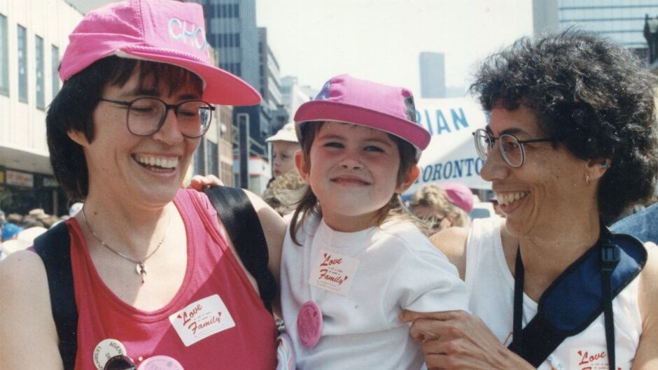 Makeda Zook, centre, with her moms at Toronto Pride in 1992.