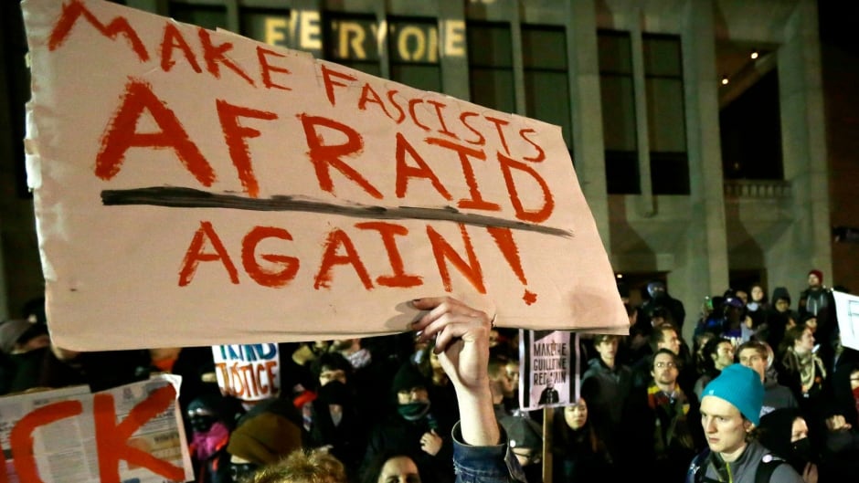 A protester holds a sign that reads "Make Fascists Afraid Again!" during a demonstration on Jan. 20, 2017 at the University of Washington campus, where far-right commentator Milo Yiannopoulos was giving a speech.