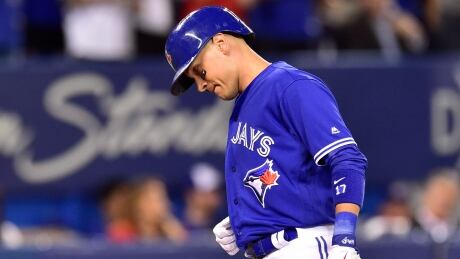 Toronto Blue Jays' Ryan Goins reacts as he crosses home plate after hitting a solo home run against the Baltimore Orioles. goins-ryan