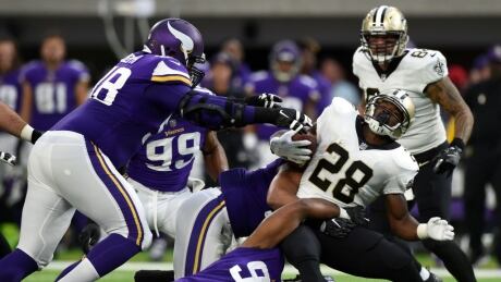 New Orleans Saints' Adrian Peterson (28) is tackled with the ball in the first quarter of a game against the Minnesota Vikings. peterson-adrian