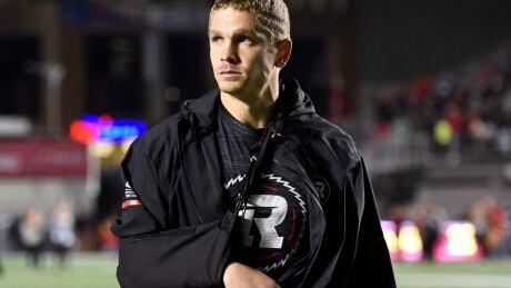 Ottawa Redblacks quarterback Trevor Harris, his arm in a sling, walks off the field following his team's loss to the Hamilton Tiger-Cats on Saturday. FBO CFL TiCats Redblacks 20170909