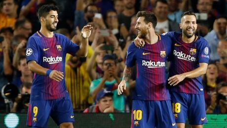 Barcelona's Luis Suarez, left, and Jordi Alba, right, celebrate with Lionel Messi after his goal in a 3-0 win over Juventus in Champions League play Tuesday. messi-lionel