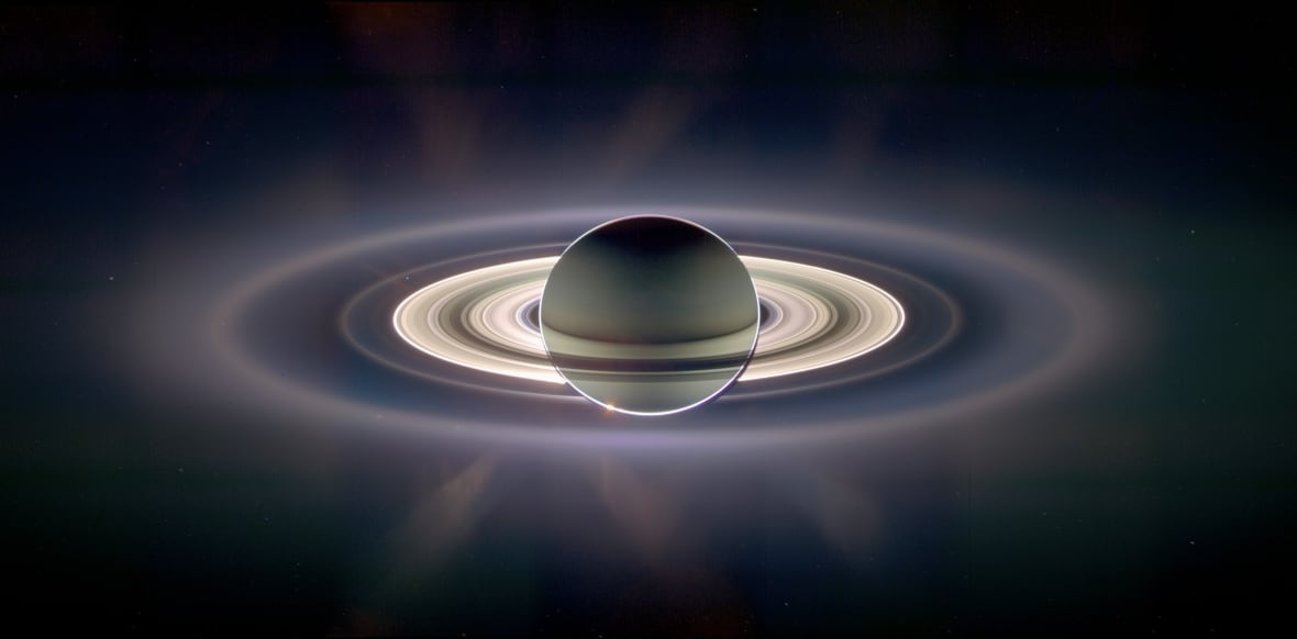 Rings surround a planet hanging in space.