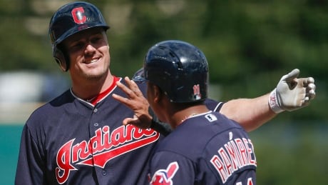 Cleveland right-fielder Jay Bruce celebrates with Jose Ramirez after hitting a three-run home run off Tigers starting pitcher Buck Farmer during the first inning on Wednesday afternoon. Cleveland won 5-3 for its 21st straight victory, an American League record. bruce-jay-170913-1180
