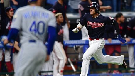 Erik Gonzalez, right, scored the game-tying run in the ninth inning before Cleveland scored another in the following inning to walk off the Kansas City Royals and extend their win streak to 22. erik-gonzalez