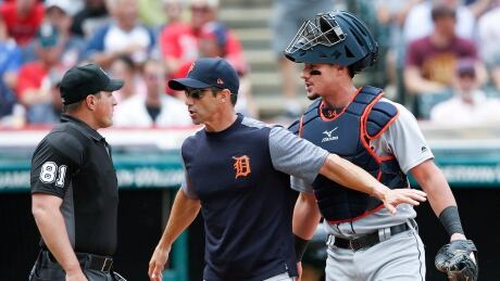 Home plate umpire Quinn Wolcott, left, was struck by a pitch during the third inning and is seen arguing with Detroit Tigers manager Brad Ausmus, middle, and catcher James McCann on Wednesday in Cleveland. wolcott-quinn-tigers-091317-620