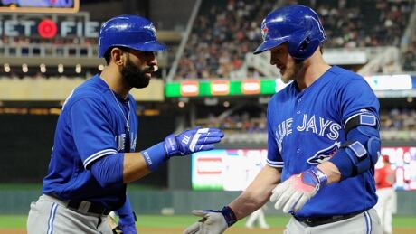 Josh Donaldson, right, is congratulated by Jose Bautista, after his sixth-inning home run during the Jays victory over the Twins Friday. donaldson-josh-bautista-jose-091517