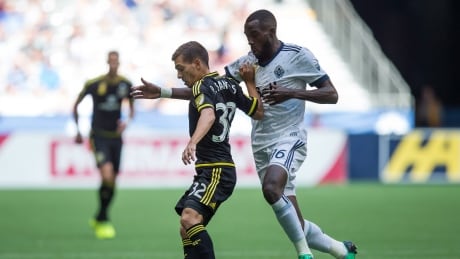 Tony Tchani, right, of the Whitecaps vies for the ball against Pedro Santos of the Crew during Vancouver's 2-2 draw on Saturday. Crew-Whitecaps-16092017