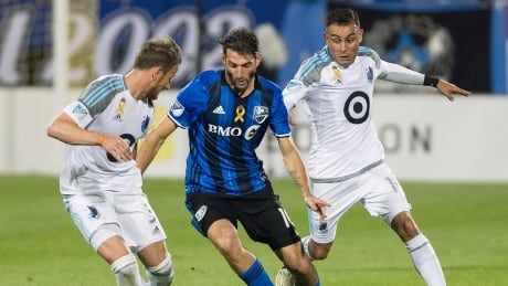 Ignacio Piatti, centre, of the Impact is challenged by Jerome Thiesson, left, and Johan Venegas of Minnesota United during Montreal's 3-2 loss on Saturday. Loons-Impact-16092017