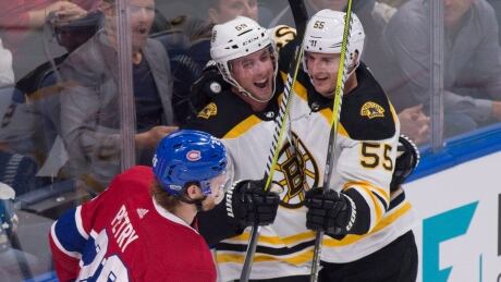 Boston Bruins forward Tim Schaller (59) is congratulated by forward Noel Acciari after he scored the game-winning goal against the Montreal Canadiens in the second period. bruins-canadiens