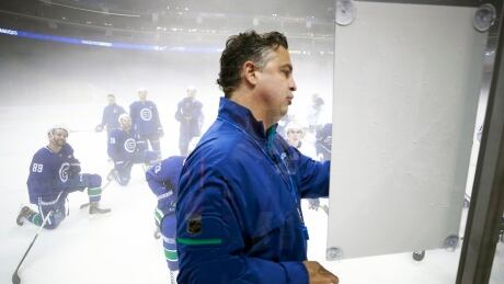 Canucks head coach Travis Green draws up a drill in the foggy Mercedes Benz Arena in Shanghai. Travis Green