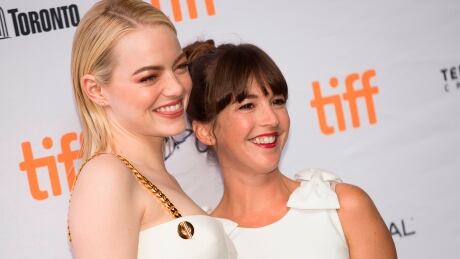 Emma Stone, left, and Martha MacIsaac pose for photographers at the premiere of'Battle of the Sexes at the Toronto International Film Festival in Toronto, Ont., Sept. 10, 2017. AFP_SB2BU