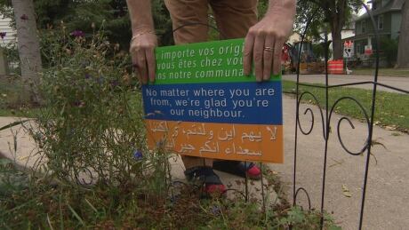 A Winnipeg woman has begun selling lawn signs with a welcoming message for newcomers as a fundraiser for the Manitoba Interfaith Immigration Council. Welcome sign