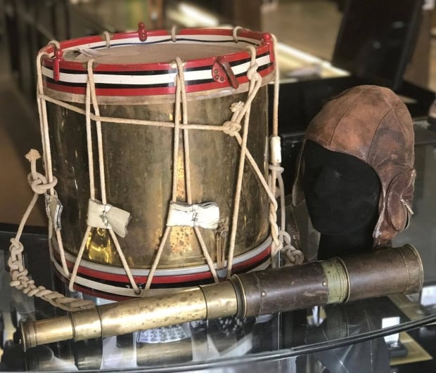 antique drum, leather football helmet and spy glass