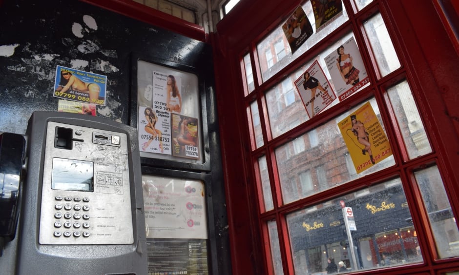 Ads in unused London phone booths