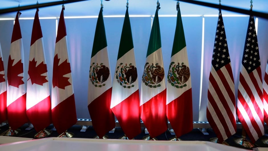 National flags representing Canada, Mexico, and the U.S. are lit by stage lights at the North American Free Trade Agreement, NAFTA, renegotiations, in Mexico City, Tuesday, Sept. 5, 2017.