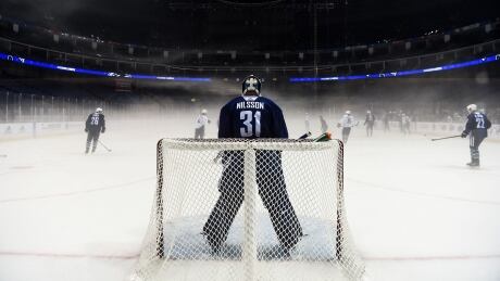 Vancouver Canucks' goaltender Andres Nilsson guards his post at the foggy Mercedes-Benz arena during Canucks practice, ahead of Thursday's pre-season game against the Los Angeles Kings in Shanghai. AFP_SK2L0