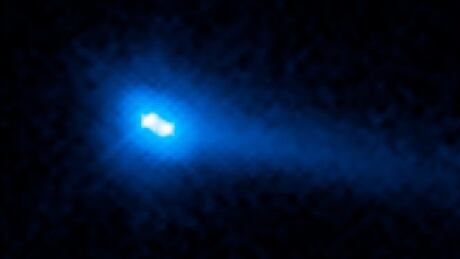 This image from the Hubble Space Telescope reveals two asteroids with comet-like features orbiting each other. These include a bright halo of material, called a coma, and a long tail of dust. Binary asteroid comet
