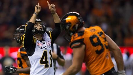 Hamilton Tiger-Cats' Sergio Castillo, left, celebrates after kicking a field goal as B.C. Lions' Craig Roh walks to the sideline during the second half in Vancouver, B.C., on Friday. FBO CFL Tiger Cats Lions 20170922