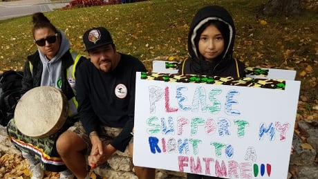 A child at Saturday's Rally for Indigenous Rights hold a sign saying 'Please support my right to a future!!!' A child at Saturday's Rally for Indigenous Rights hold a sign saying 'Please support my right to a f