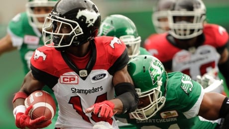 Calgary Stampeders running back Roy Finch tries to break a tackle during first half against the Saskatchewan Roughriders. stampeders-roughriders