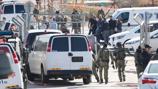 Israeli security deploys at an entrance to Har Adar settlement near Jerusalem Tuesday. Israeli police said a Palestinian man opened fire at the entrance to the settlement killing three Israeli men and critically wounding a fourth