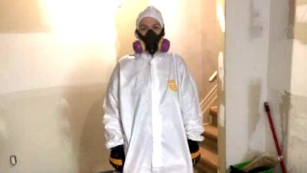 Claudette Charron in a hazmat suit