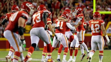 Kansas City Chiefs kicker Harrison Butker is mobbed by teammates after kicking the go-ahead field goal with 8 seconds remaining during the 4th quarter. butker-harrison
