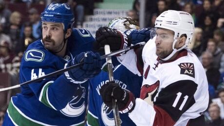 Vancouver Canucks defenceman Erik Gudbranson, left, is part of a dwindling group of players in the NHL that still chooses to play without a visor. canucks-gudbranson-erik-111716-620