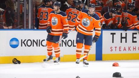 Connor McDavid smiles watching the hats rain down after his hat trick in Edmonton's season-opening win against the Flames. mcdavid-connor-100617