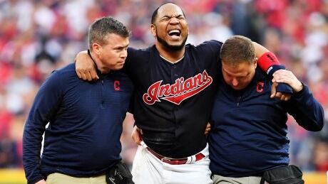 Edwin Encarnacion, centre, is helped off the field in the first inning Friday with an apparent right ankle injury. edwin-encarnacion