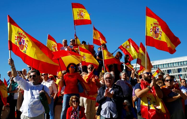 Anti-independence Catalan protestors carry Spanish and catalan flag during  a demonstration for the unity of Spain on the occasion of the Spanish Natio  Stock Photo - Alamy