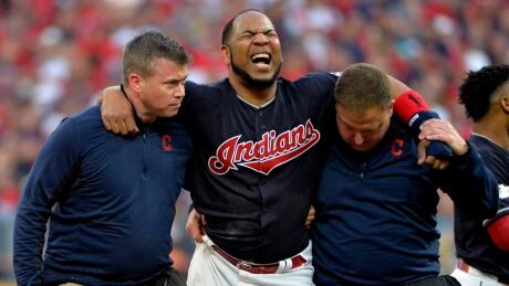 Cleveland Indians' Edwin Encarnacion is carried off the field after rolling his ankle at second base in the second inning of Game 2 against the New York Yankees on Friday. encarnacion-edwin-100617-620