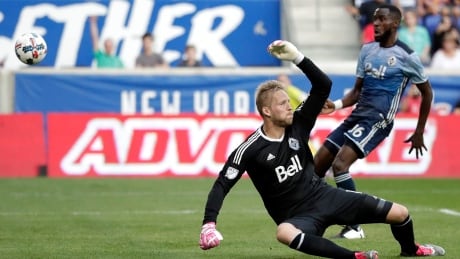 Vancouver Whitecaps goalkeeper David Ousted has the ball fly over his head for New York City's first goal in their 3-0 victory Saturday. ousted-david-100717