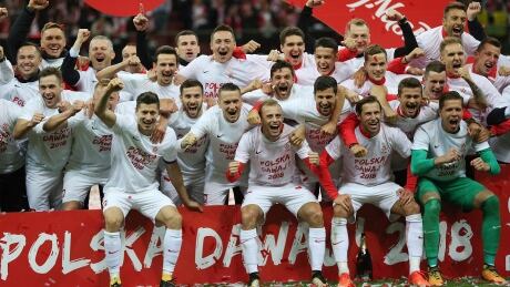 Poland players celebrate after winning their last World Cup Group E qualifying soccer match against Montenegro to qualify. poland