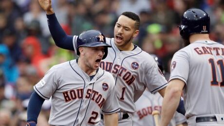 Astros' Alex Bregman celebrates his eight-inning home run with teammates Carlos Correa, rear, and Evan Gattis, during Hoston's 5-4 ALDS series clinching win over the Boston Red Sox on Monday. RedSox-Houston-09102017