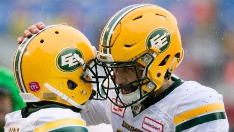 Edmonton Eskimos quarterback Mike Reilly, right, celebrates with teammate C.J. Gable following a touchdown during the first half. eskimos-alouettes