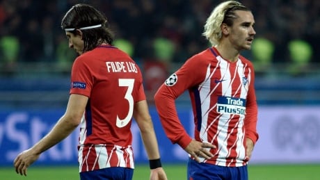 Atletico Madrid's Antoine Griezmann, right, and Filipe Luis react following the team's draw against Qarabag on Wednesday. AFP_TI6LL