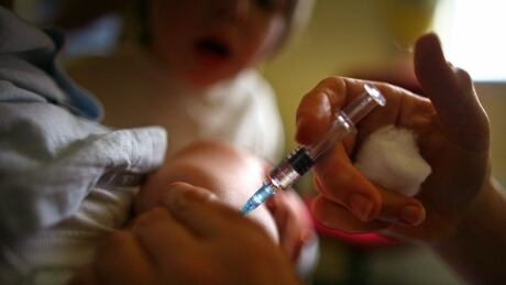 A young boy receives a immunization jab at a health centre in Glasgow September 3, 2007 in Glasgow, Scotland. Medical experts still believe the MMR jab is safe and that the vaccine does not cause autism. GYI0000650631.jpg