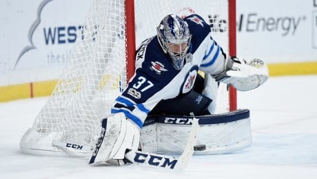 Winnipeg's Connor Hellebuyck makes a stick save during the Jets' 2-1 win over the Minnesota Wild Tuesday. hellebuyck-connor-103117