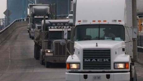 Transport trucks move slowly across the Ambassador Bridge into Detroit, Michigan from Windsor, Ontario, Canada, March 19, 2003 after the United States tightened security at the border crossings ahead of a possible U.S. led invasion of Iraq. U.S. Homeland Security Secretary Tom Ridge tried on Wednesday to calm a jittery nation ahead of war with Iraq and voiced confidence at tough measures to prevent retaliation from enemies such as Osama bin Laden. REUTERS/Rebecca Cook Ambassador Bridge border crossing