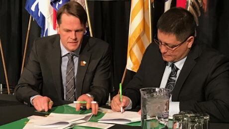Mayor Charlie Clark and Saskatoon Tribal Council Chief Mark Arcand sign memo of understanding. Signing