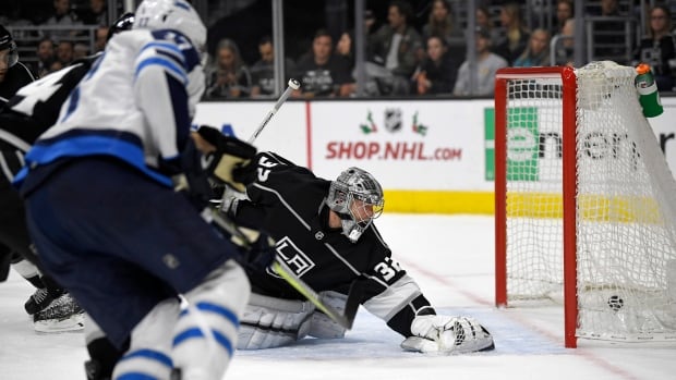Adam Lowry left of the Jets scores on Kings' goalie Jonathan Quick during Winnipeg's 2-1 win on Wednesday in Los Angeles Calif