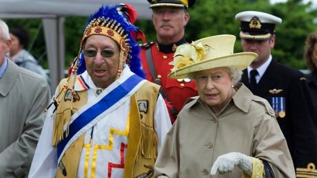 Queen Elizabeth, accompanied by Grand Chief Ben Sylliboy, attends a Mi'kmaq cultural event in Halifax in this June 28, 2010 file photo. Queen Visit 20100628
