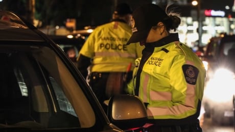 A VPD officer checks the licence of a driver she pulled over. STOCK VANCOUVER POLICE DEPARTMENT OFFICER TRAFFIC UNIT DRINKING AND DRIVING LIQUOR