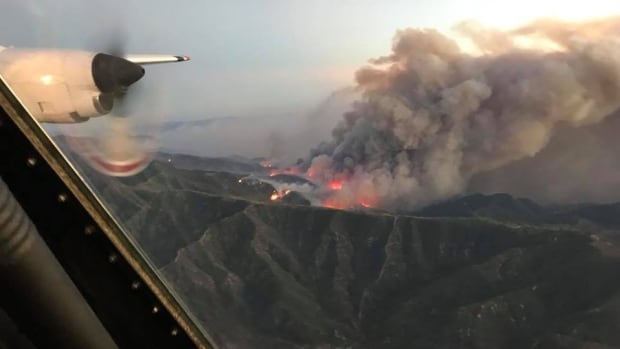Coulson Air's Tanker 131 flies over the Thomas fire in Santa Barbara County, California Dec. 8. 