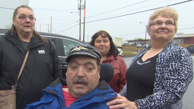 Philip Drover of St. John's received the gift of accessible transportation Wednesday in the form of a donation of a wheelchair-adapted van from the widow of highway safety advocate Ben Bellows, Helen Bellows, right. Drover's wife, Brenda McKay, left, and Lucy Stoyles of an action committee fighting to reduce the number of moose-vehicle collision are also pictured.
