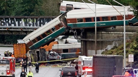 Cars from an Amtrak train lay spilled onto Interstate 5 below alongside smashed vehicles as some train cars remain on the tracks above Monday in DuPont, Wash. APTOPIX Train Derailment Washington State