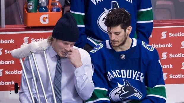 Vancouver Canucks right wing Brock Boeser is seen with crutches as he speaks to centre Nic Dowd following a loss to the Calgary Flames on Sunday. 